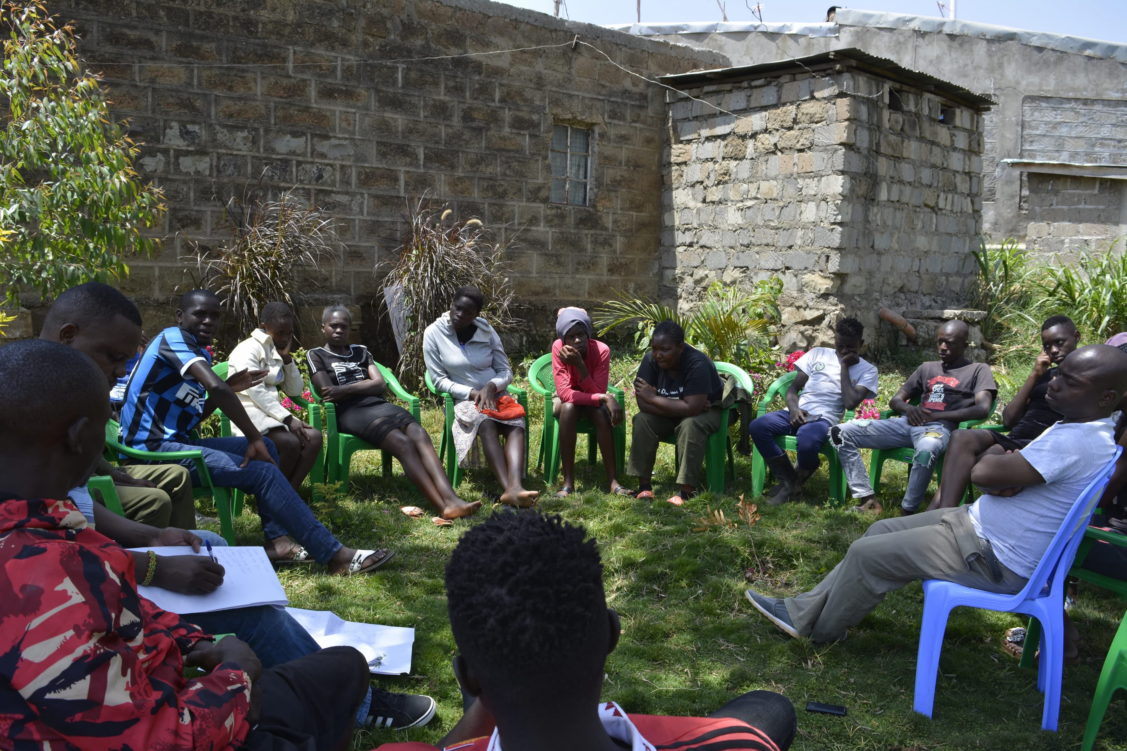 Community focus group discussion with a YIKE researcher taking notes